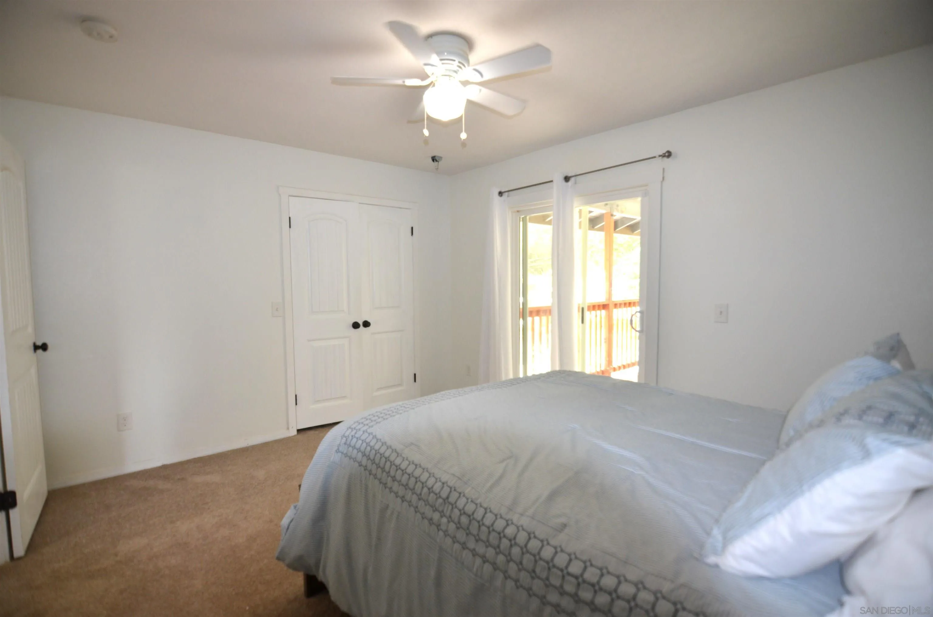 30643 Rabbit Run Valley Center, CA 92082 - Photo 18 of 59 a bedroom with a bed and a chandelier