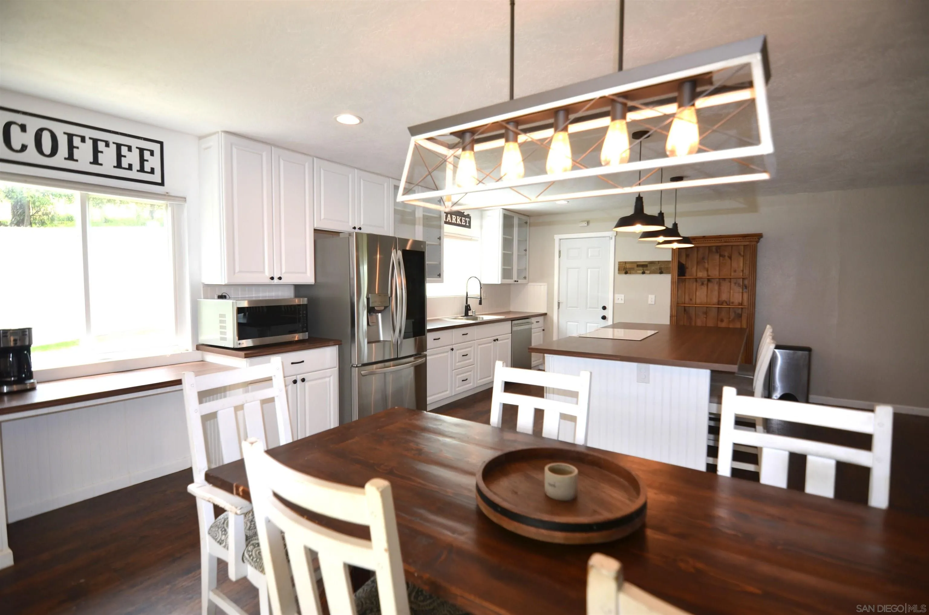 30643 Rabbit Run Valley Center, CA 92082 - Photo 3 of 59 a kitchen with stainless steel appliances granite countertop a sink a stove a refrigerator with a dining table and chairs
