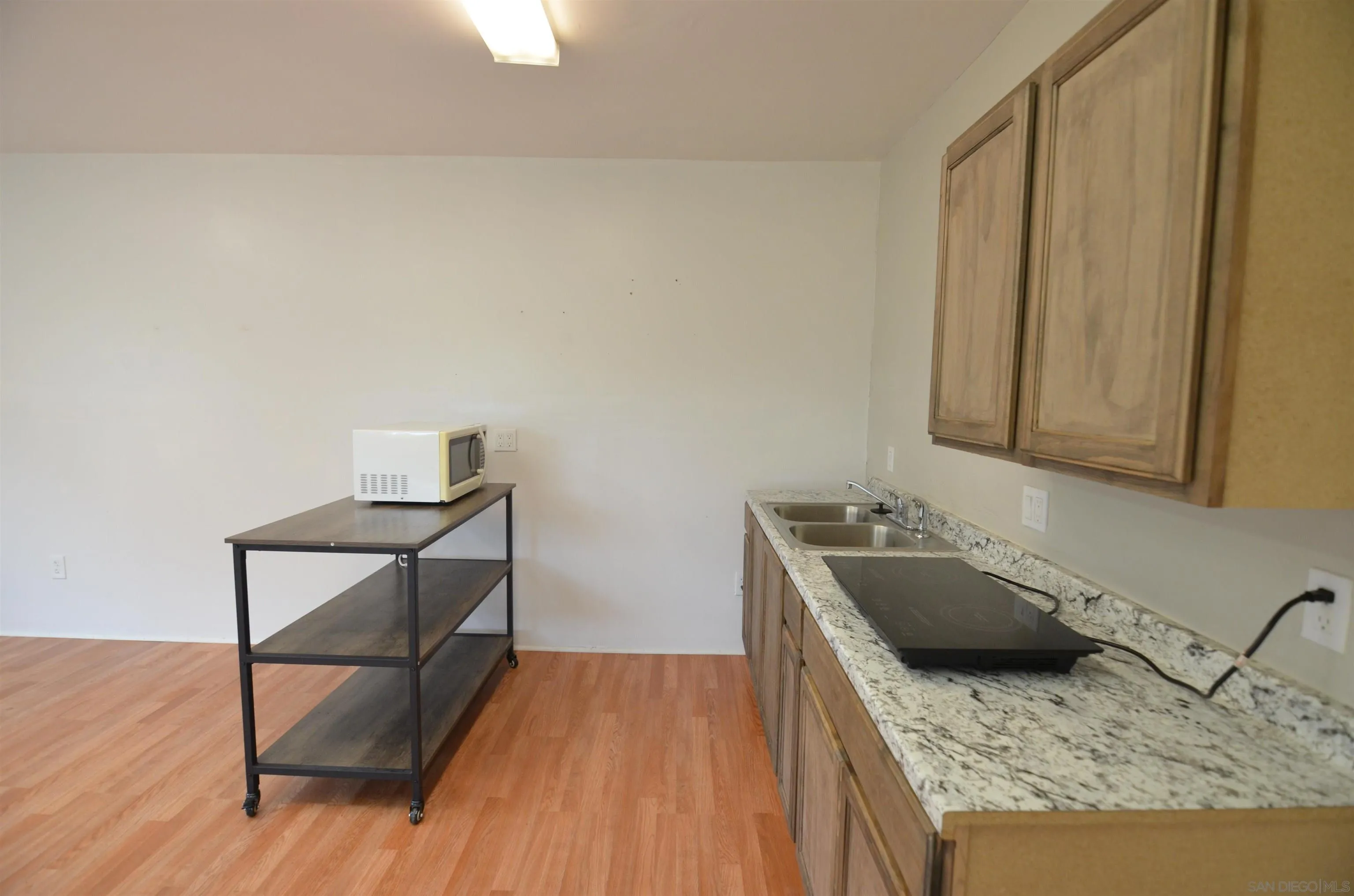 30643 Rabbit Run Valley Center, CA 92082 - Photo 36 of 59 a kitchen with a sink a stove and wooden floor