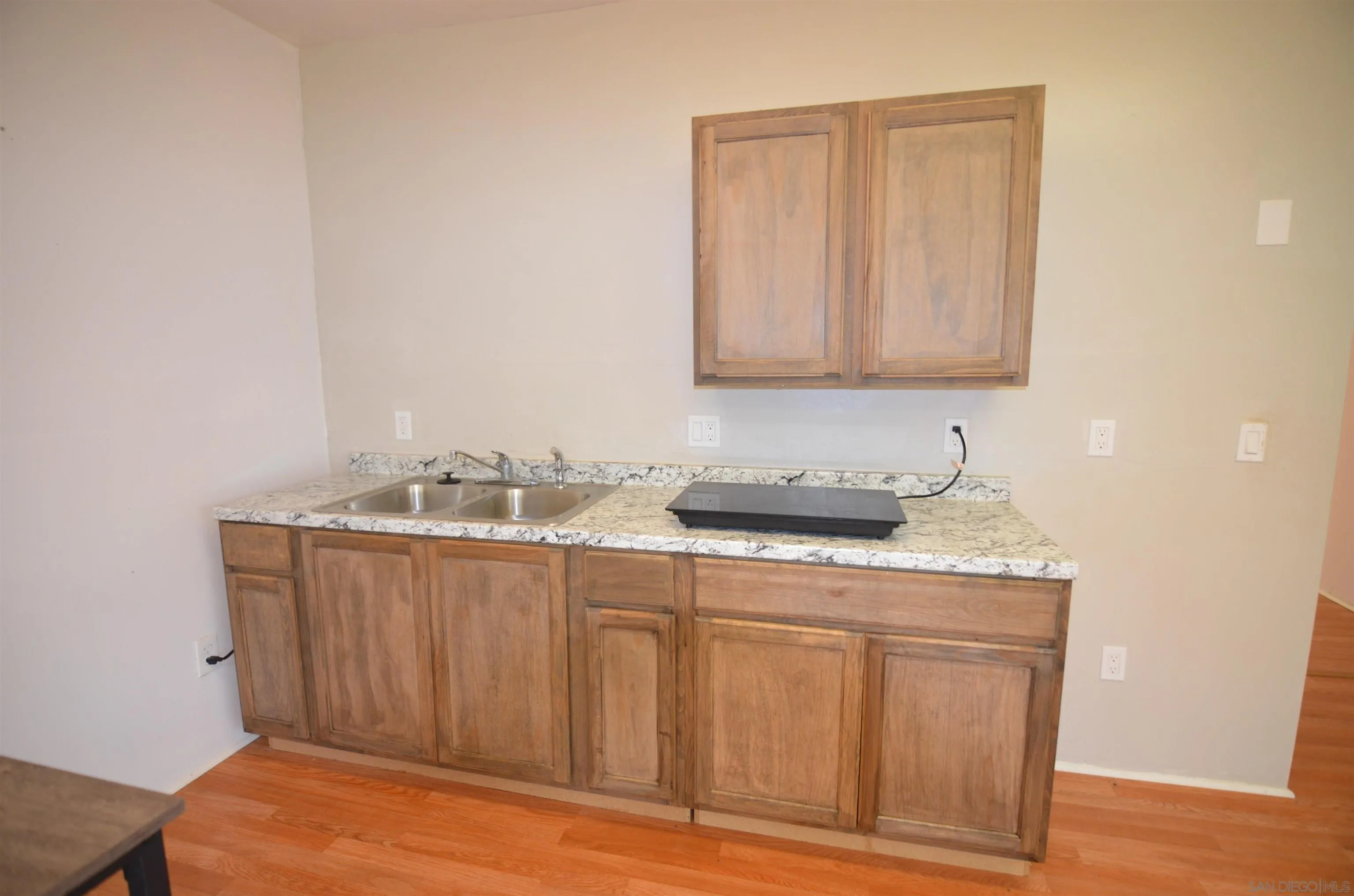 30643 Rabbit Run Valley Center, CA 92082 - Photo 38 of 59 a room with a sink cabinets and a wooden floor