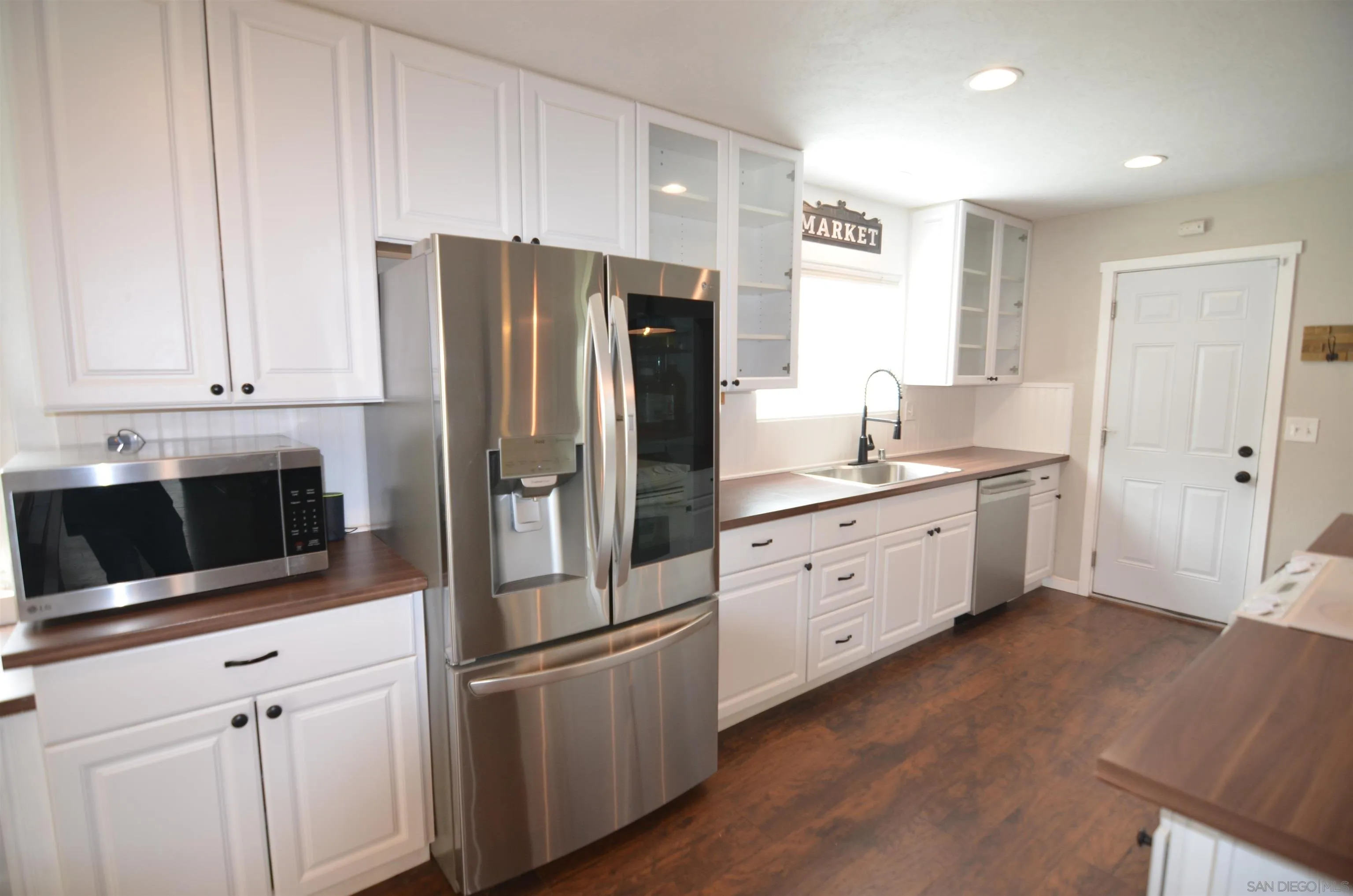 30643 Rabbit Run Valley Center, CA 92082 - Photo 4 of 59 a kitchen with stainless steel appliances white cabinets and a refrigerator
