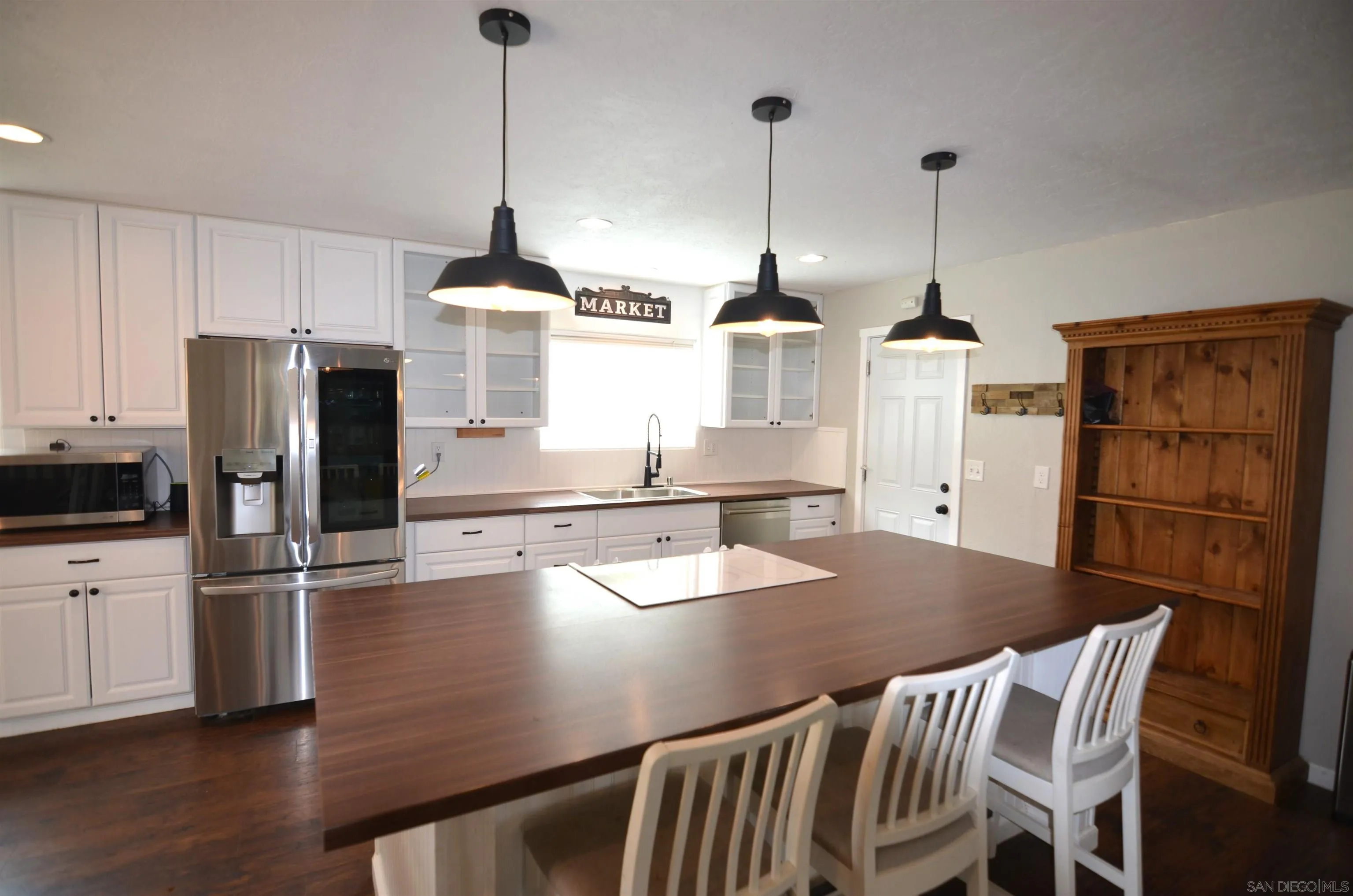 30643 Rabbit Run Valley Center, CA 92082 - Photo 6 of 59 a kitchen with appliances cabinets and wooden floor