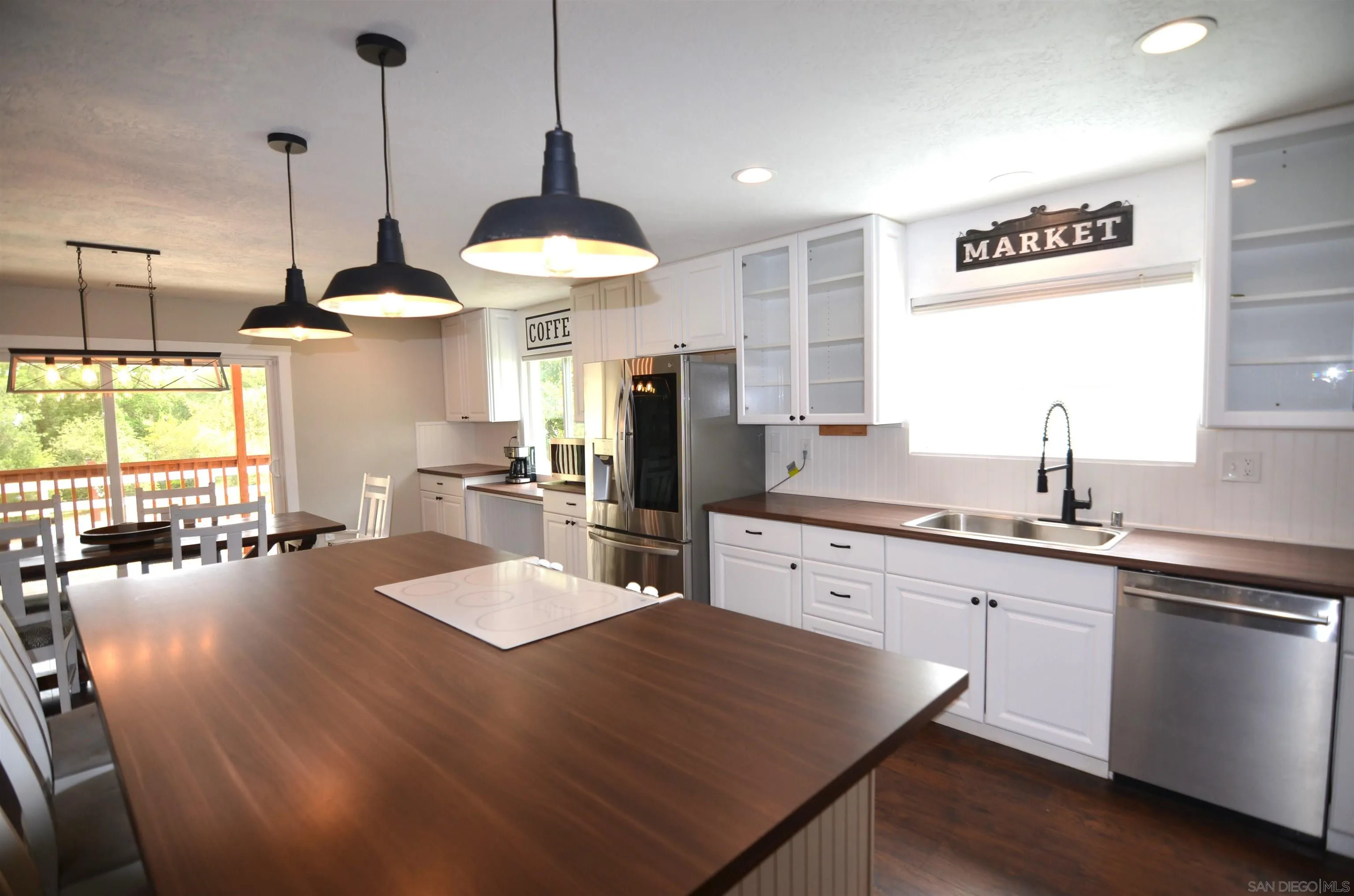 30643 Rabbit Run Valley Center, CA 92082 - Photo 7 of 59 a kitchen with stainless steel appliances granite countertop a sink a stove and chairs