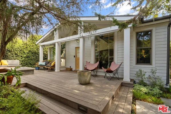 a view of a two chairs in the patio