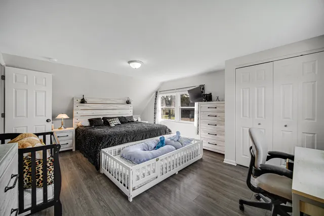 a bedroom with furniture and a wooden floor