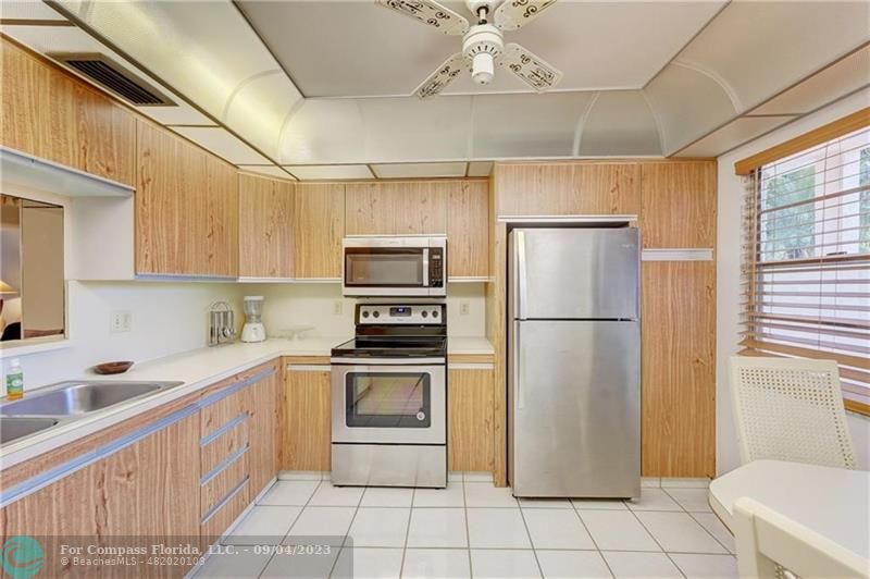 a kitchen with a refrigerator a sink dishwasher and a refrigerator