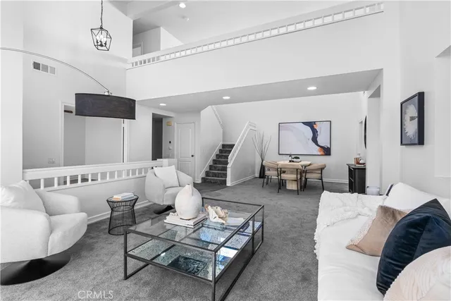 a living room with furniture and a large mirror