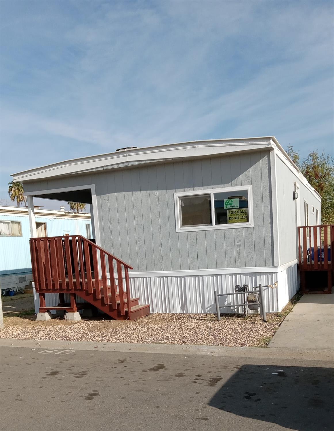 a view of a house with wooden fence