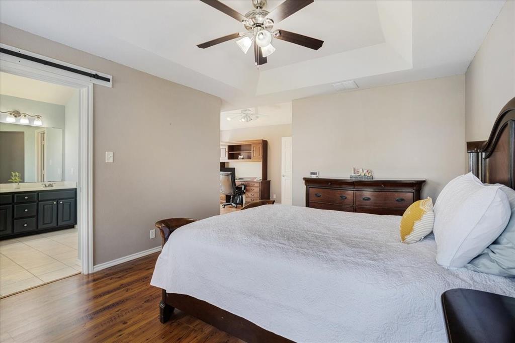 336 Old Highway 6 Howe, TX 75459 - Photo 16 of 40 a bedroom with a bed and dresser with wooden floor