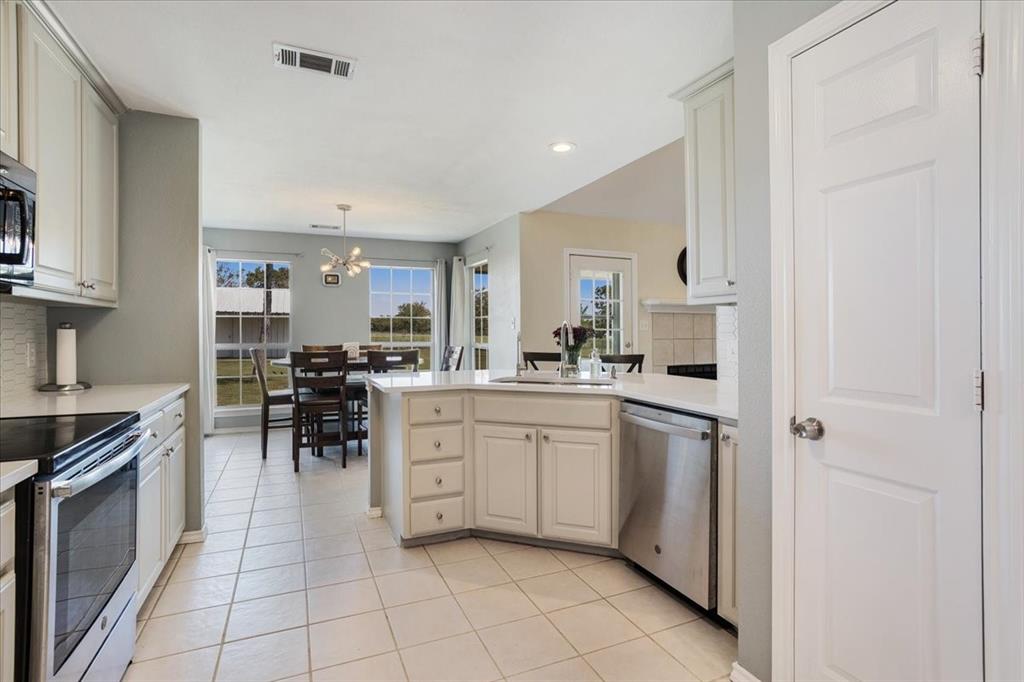 336 Old Highway 6 Howe, TX 75459 - Photo 9 of 40 a kitchen with white cabinets and appliances