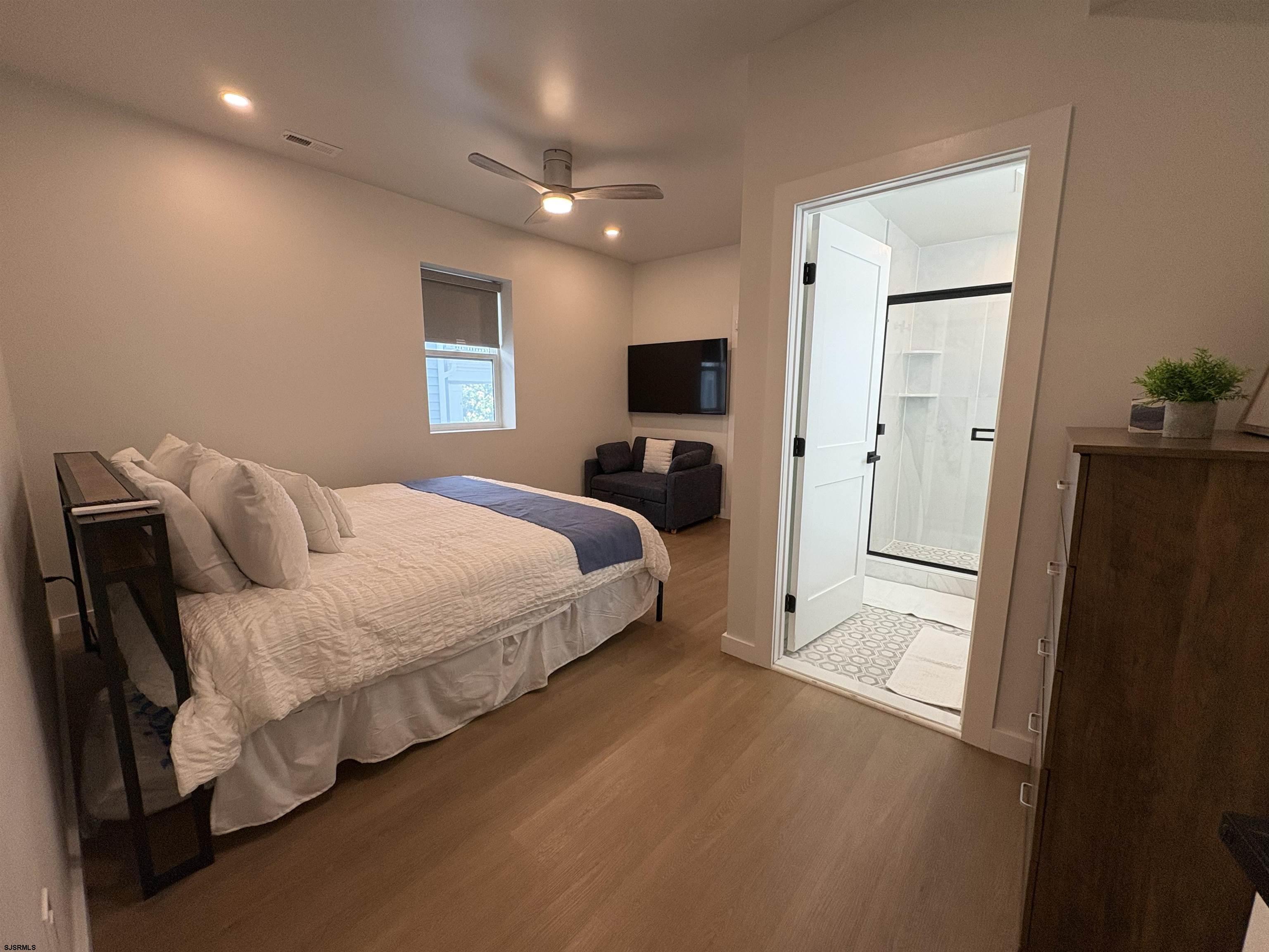 713 East 8th Street, Unit B Ocean City, NJ 08226 - Photo 14 of 25 a spacious bedroom with a bed and a walk in closet