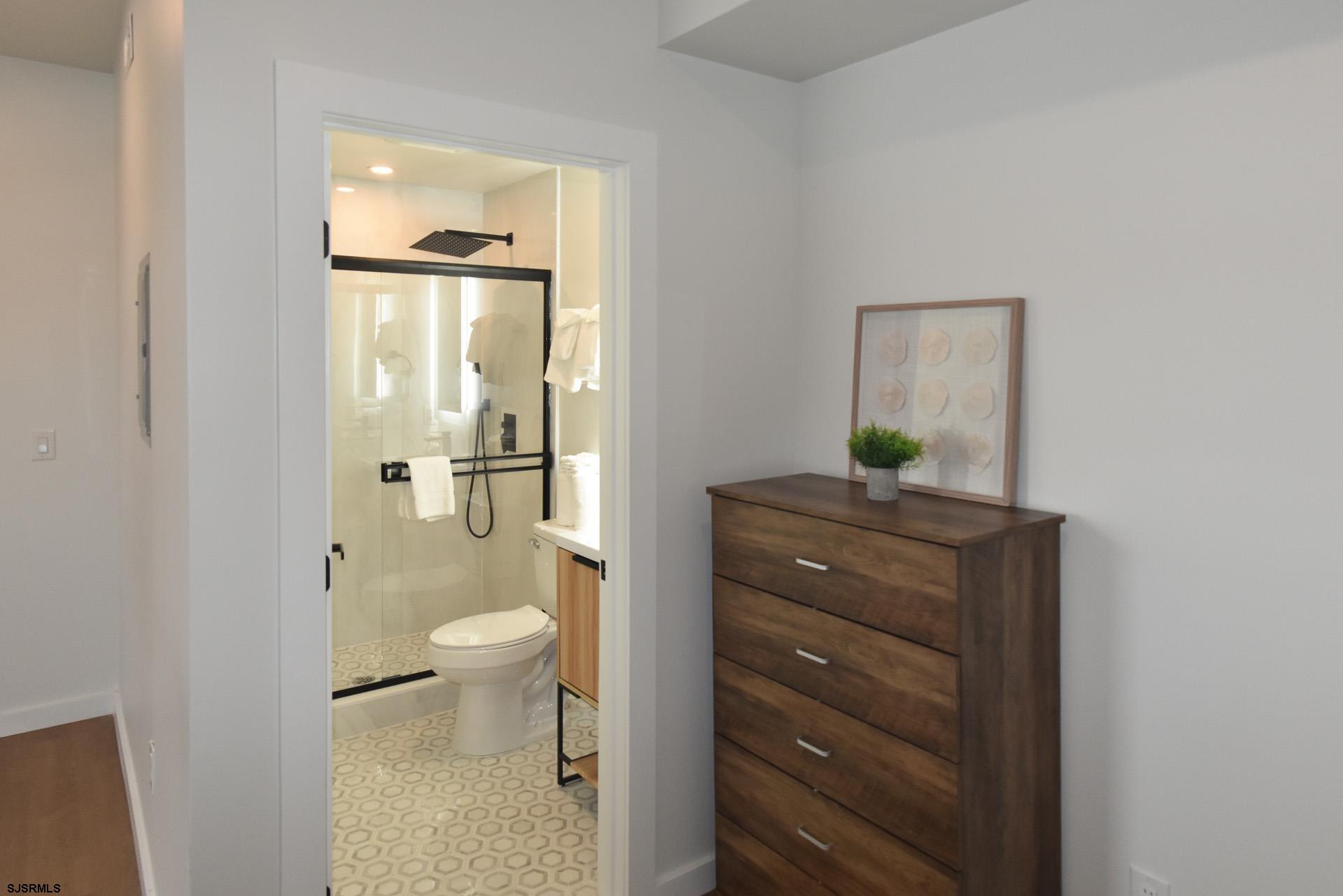 713 East 8th Street, Unit B Ocean City, NJ 08226 - Photo 15 of 25 a bathroom with a toilet a sink and shower