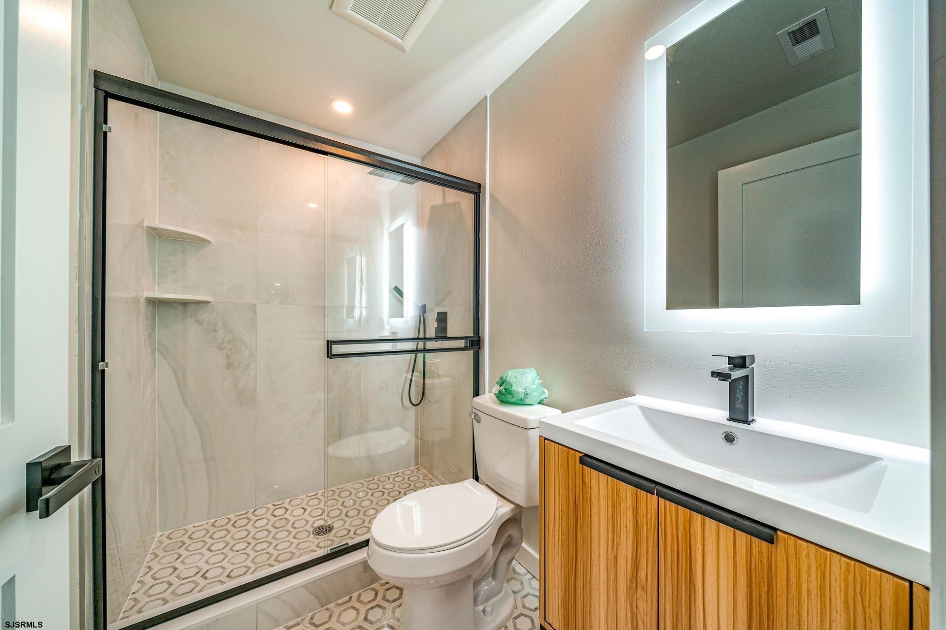 713 East 8th Street, Unit B Ocean City, NJ 08226 - Photo 16 of 25 a bathroom with a sink toilet and shower
