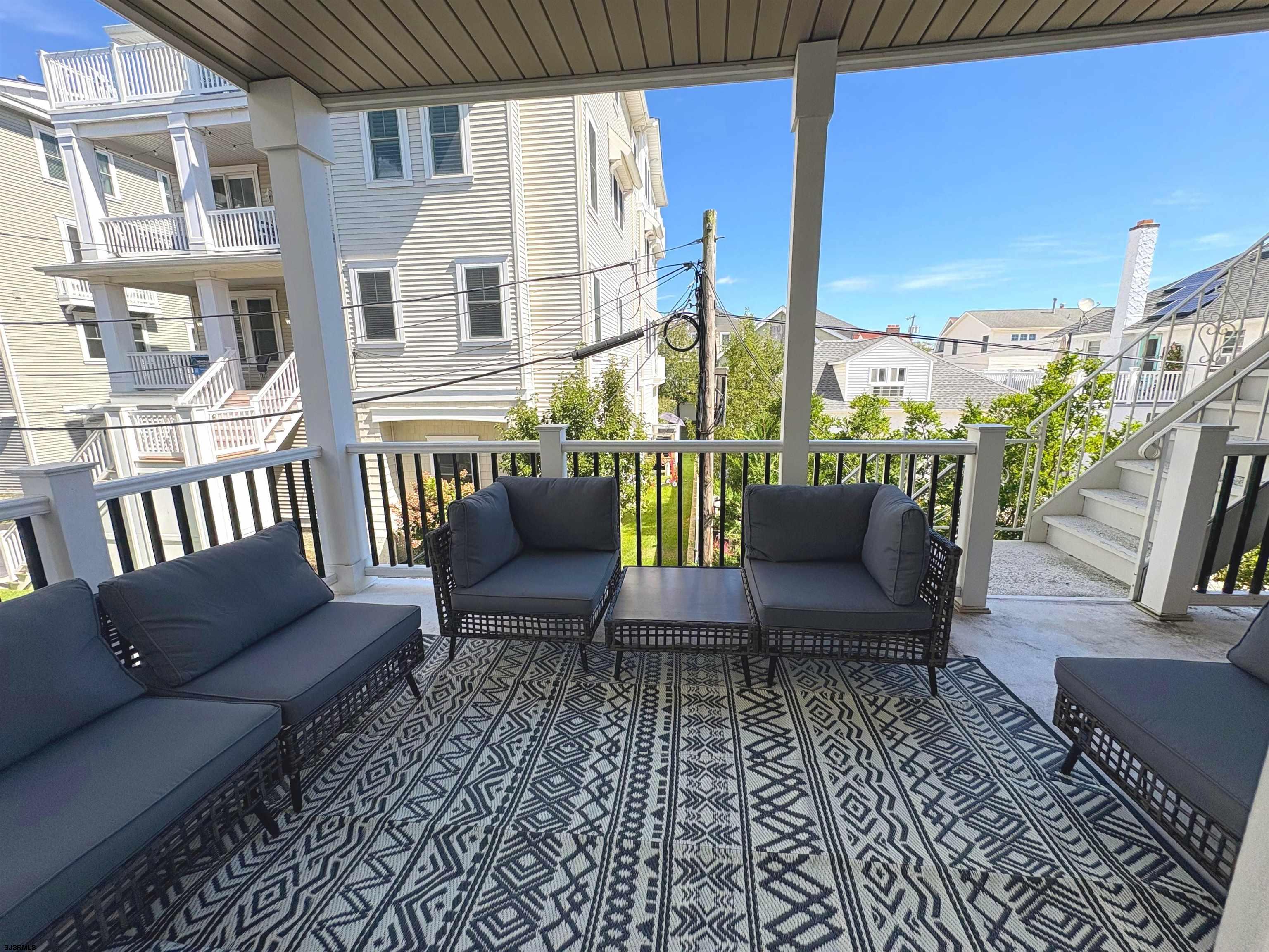 713 East 8th Street, Unit B Ocean City, NJ 08226 - Photo 17 of 25 a balcony with furniture and a potted plant