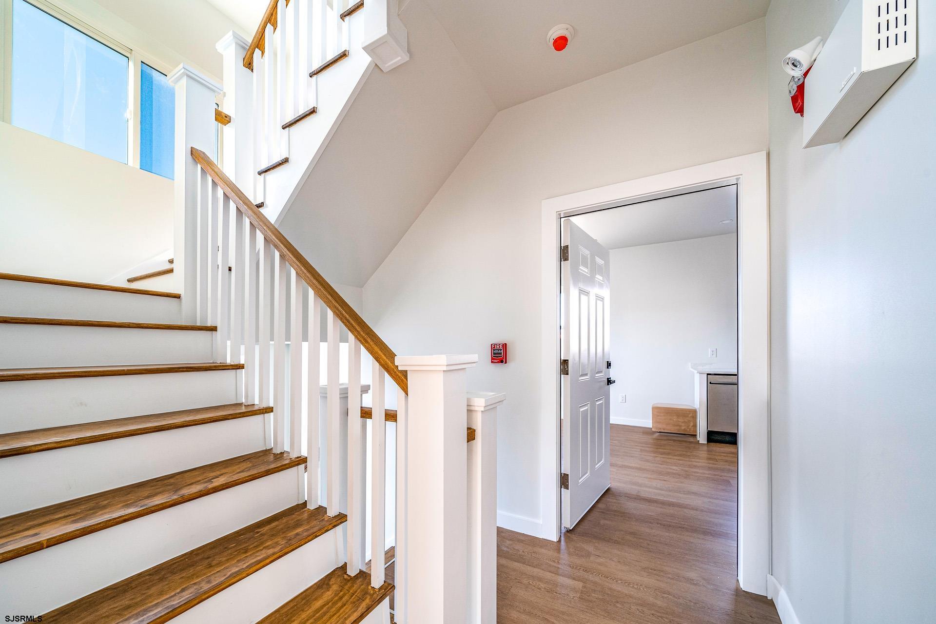 713 East 8th Street, Unit B Ocean City, NJ 08226 - Photo 3 of 25 a view of a hallway with wooden floor and entryway