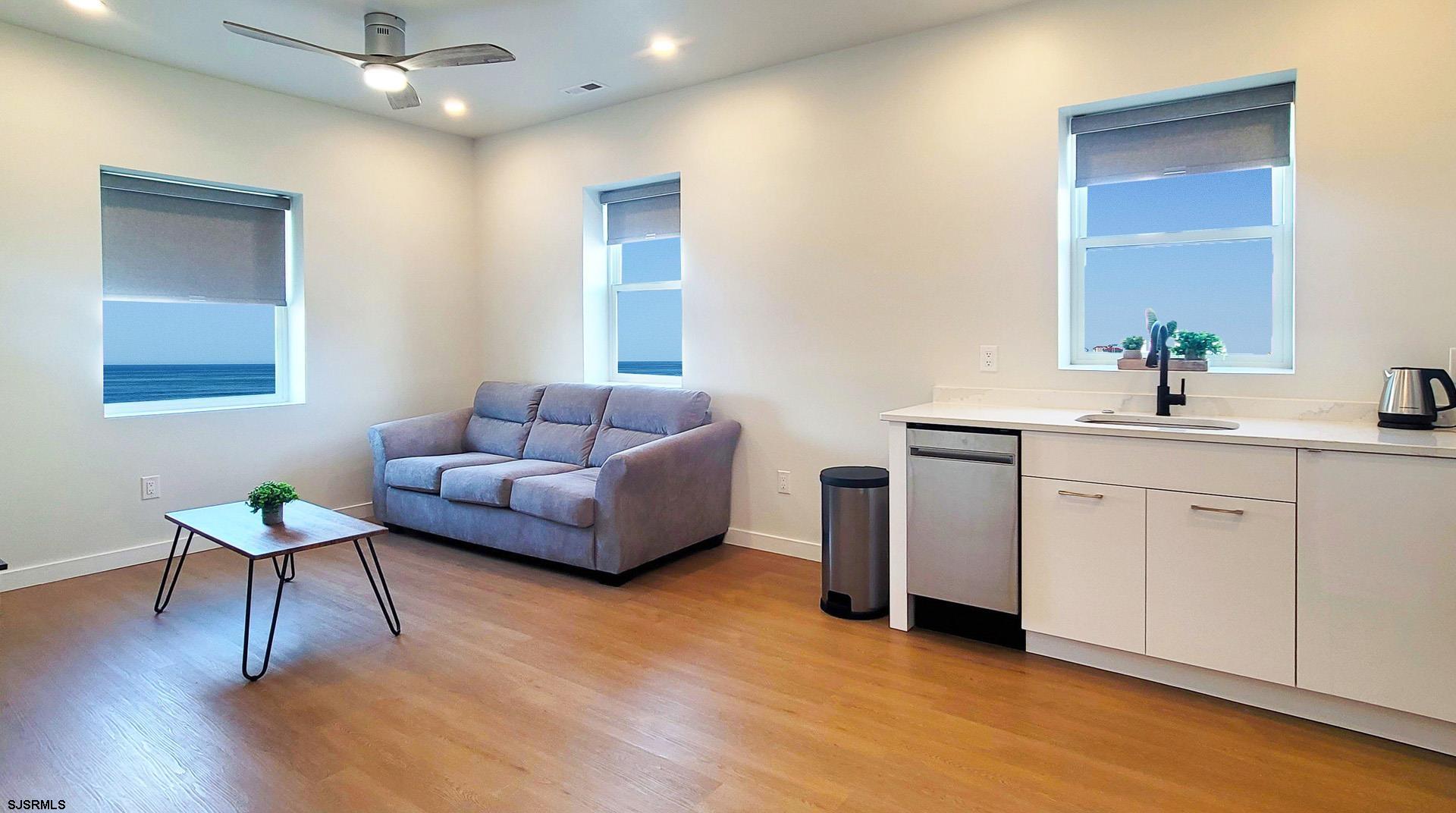 713 East 8th Street, Unit B Ocean City, NJ 08226 - Photo 5 of 25 a living room with furniture and a wooden floor