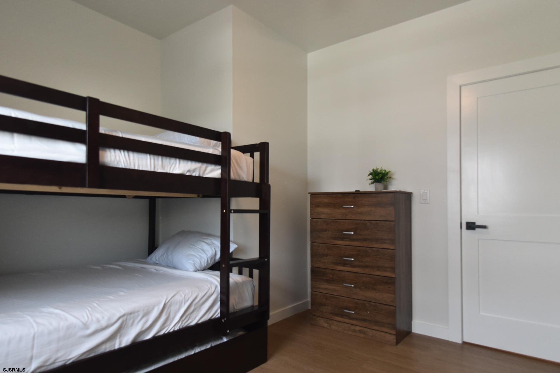 713 East 8th Street, Unit B Ocean City, NJ 08226 - Photo 10 of 25 a bedroom with a bed and a dresser