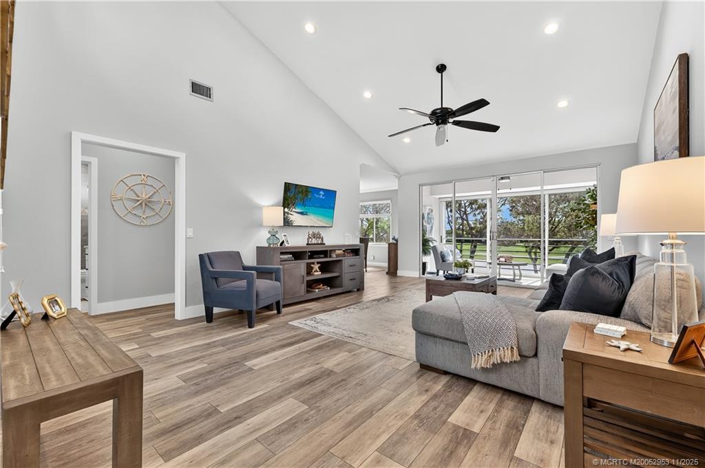 12463 Harbour Ridge Boulevard, Unit 26 Palm City, FL 34990 - Photo 1 of 34 a living room with furniture a ceiling fan and a flat screen tv