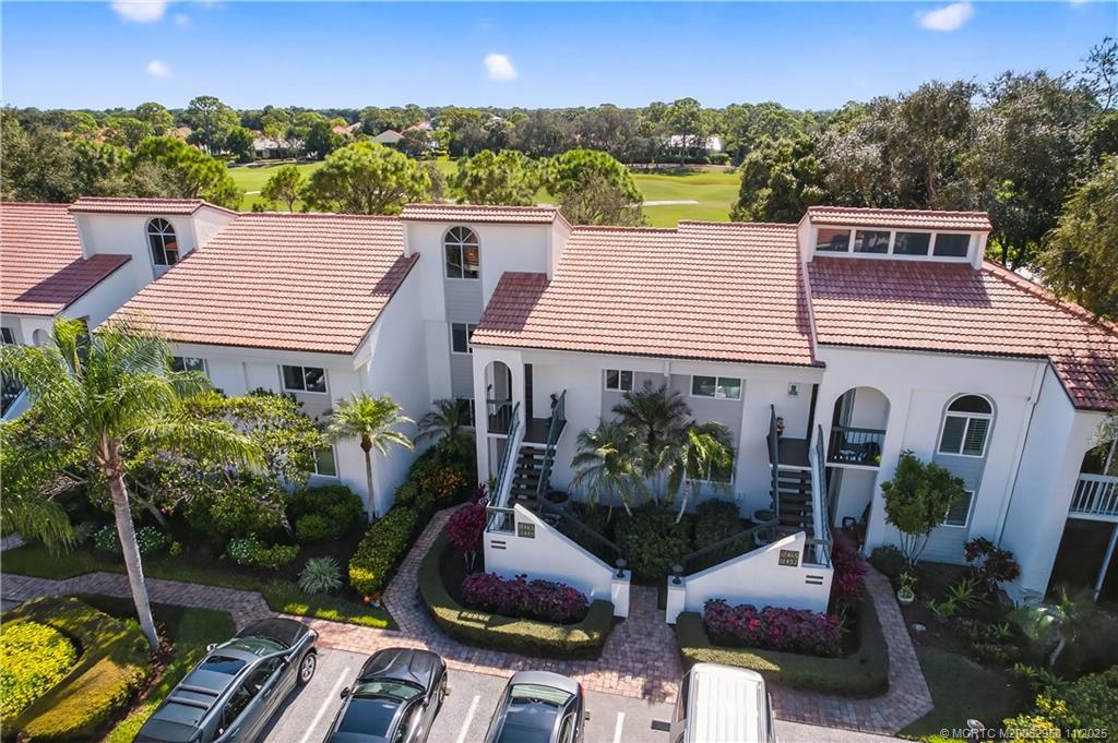 12463 Harbour Ridge Boulevard, Unit 26 Palm City, FL 34990 - Photo 23 of 34 a aerial view of a house with a yard patio and a garden