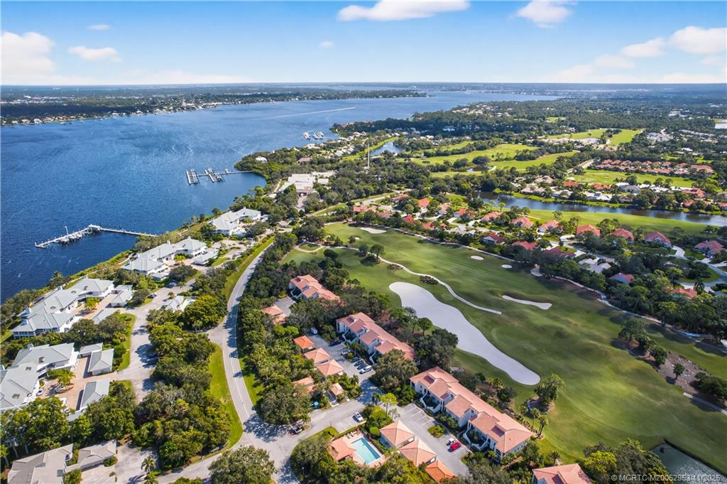 12463 Harbour Ridge Boulevard, Unit 26 Palm City, FL 34990 - Photo 28 of 34 an aerial view of a residential houses with outdoor space and trees