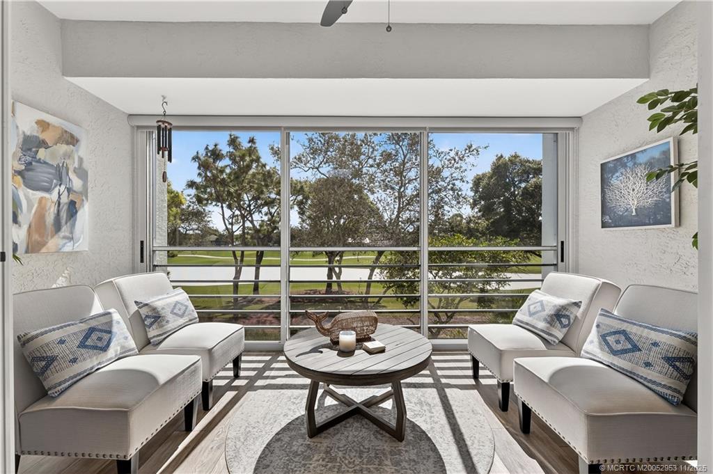 12463 Harbour Ridge Boulevard, Unit 26 Palm City, FL 34990 - Photo 6 of 34 a living room with furniture and a floor to ceiling window