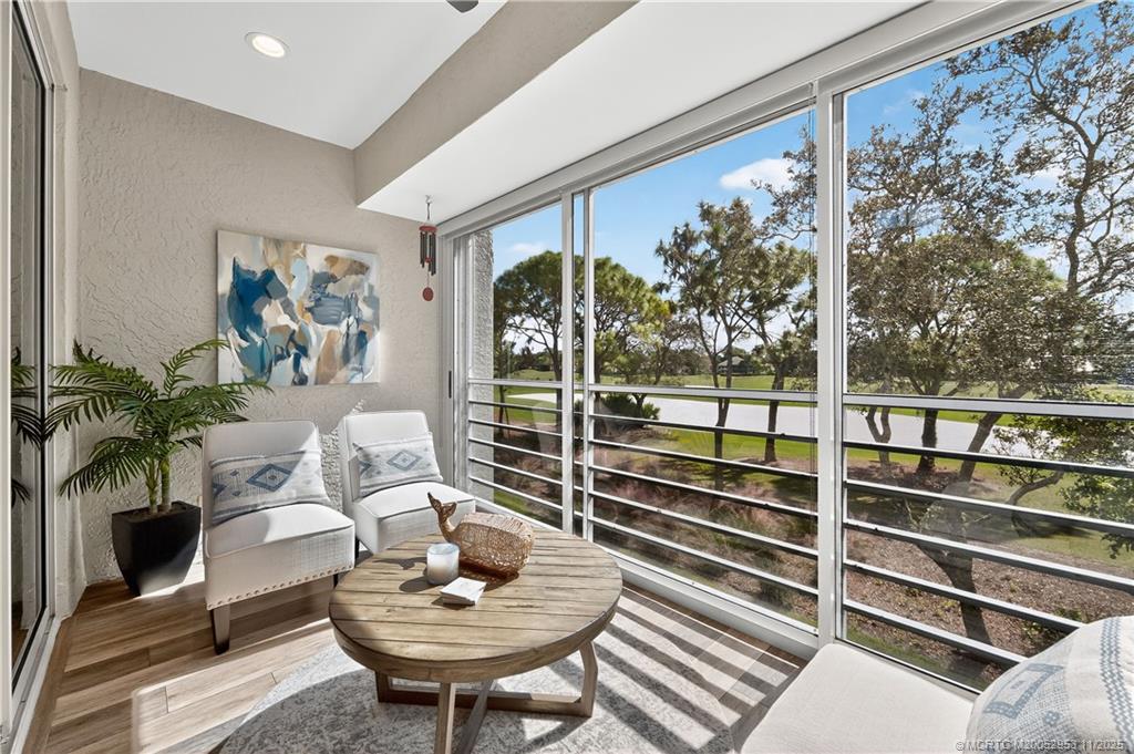12463 Harbour Ridge Boulevard, Unit 26 Palm City, FL 34990 - Photo 7 of 34 a living room with furniture and a potted plant
