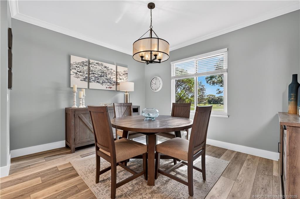 12463 Harbour Ridge Boulevard, Unit 26 Palm City, FL 34990 - Photo 8 of 34 a dining room with furniture window wooden floor