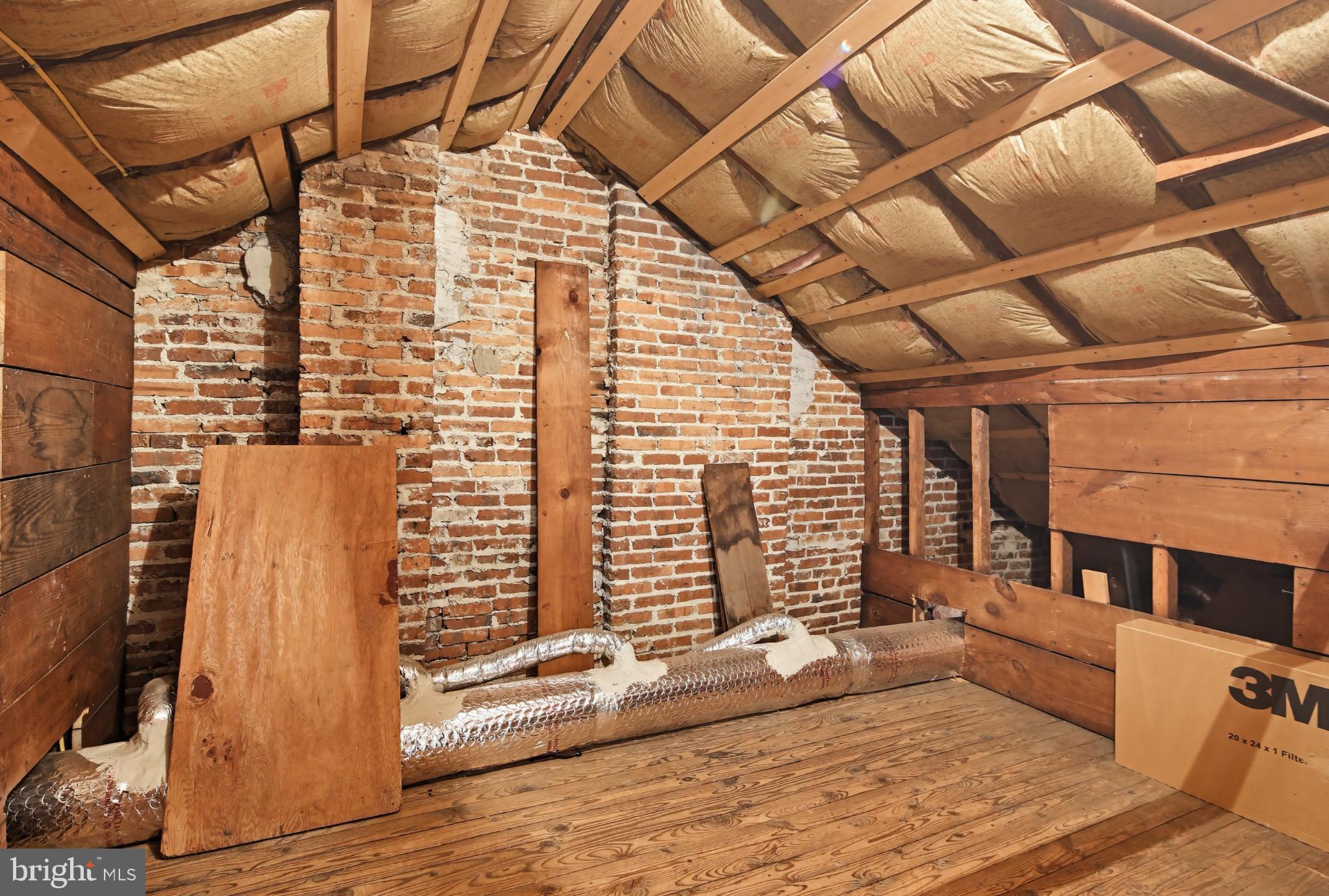3953 Cloverhill Road Baltimore, MD 21218 - Photo 24 of 54 Charming attic with rustic brick walls.