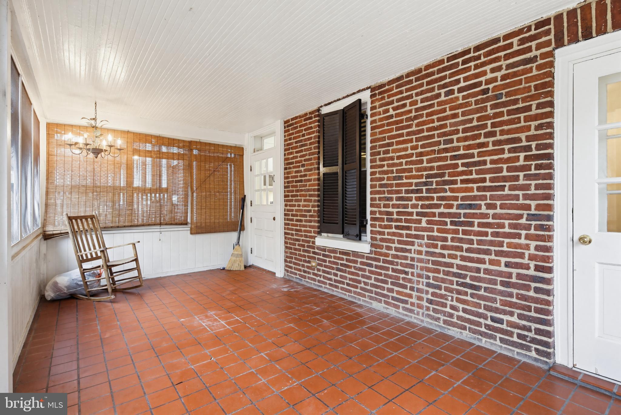 3953 Cloverhill Road Baltimore, MD 21218 - Photo 52 of 54 Charming sunlit porch with rustic brick walls.