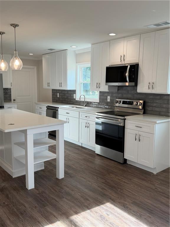 103 Barbara Ruth Drive Northwest Dalton, GA 30721 - Photo 2 of 8 a kitchen with stainless steel appliances a stove top oven a sink dishwasher and a refrigerator