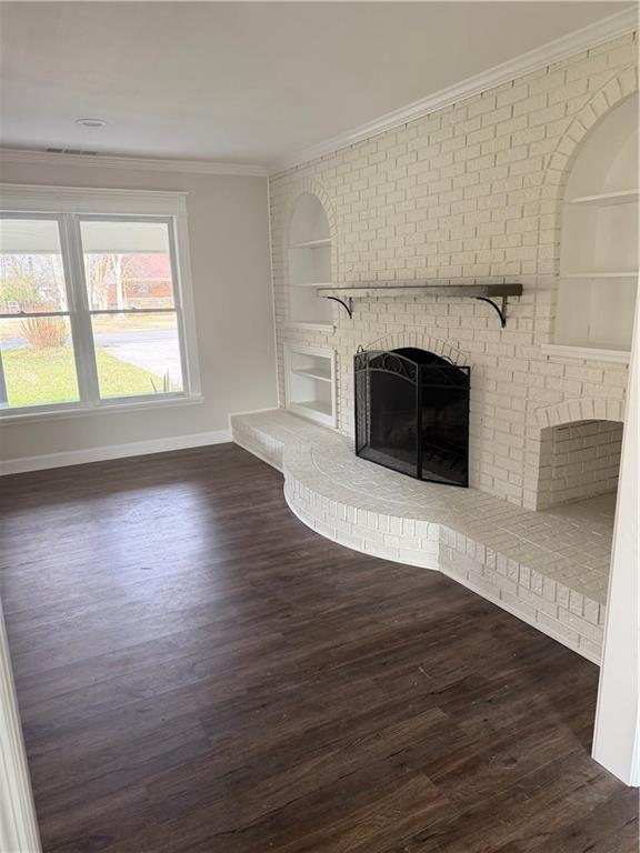 103 Barbara Ruth Drive Northwest Dalton, GA 30721 - Photo 3 of 8 an empty room with wooden floor fireplace and windows