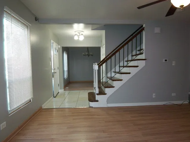 a view of entryway and hall with wooden floor
