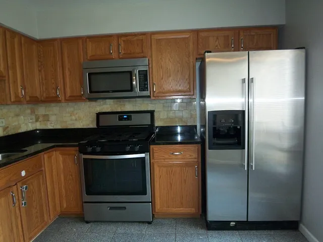a kitchen with a refrigerator and a stove