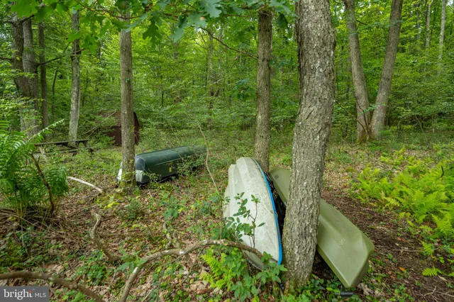 a backyard of a house with barbeque oven table and chairs