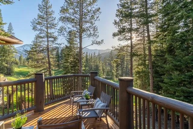 a view of a balcony with wooden floor and outdoor seating