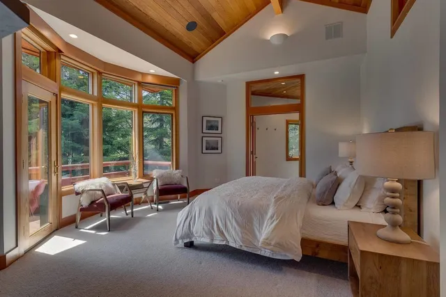 a bedroom with a bed and a large window