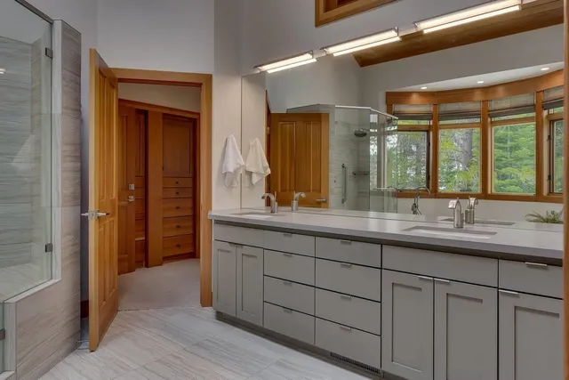 a bathroom with a double vanity sink and a mirror
