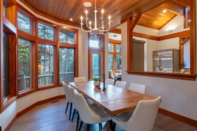 a view of a dining room with furniture large windows and wooden floor