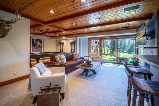 a living room with furniture and a floor to ceiling window