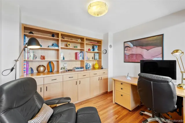 a view of a workspace with furniture and a flat screen tv