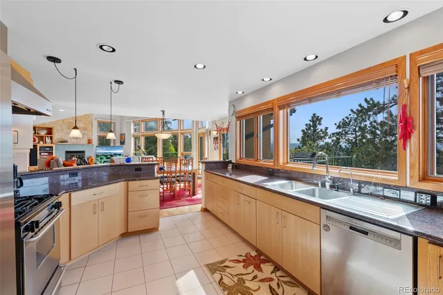 a kitchen with stainless steel appliances granite countertop a sink and cabinets