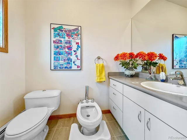 a bathroom with a sink mirror vanity and toilet