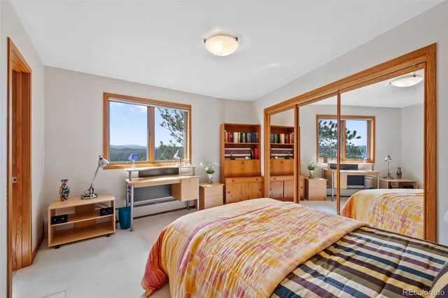 a bedroom with a bed and a large window