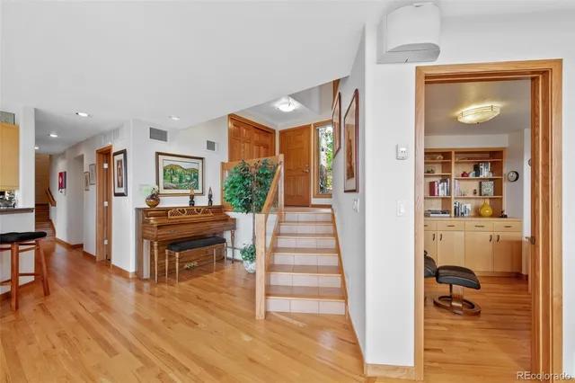 a living room with furniture wooden floor and a table