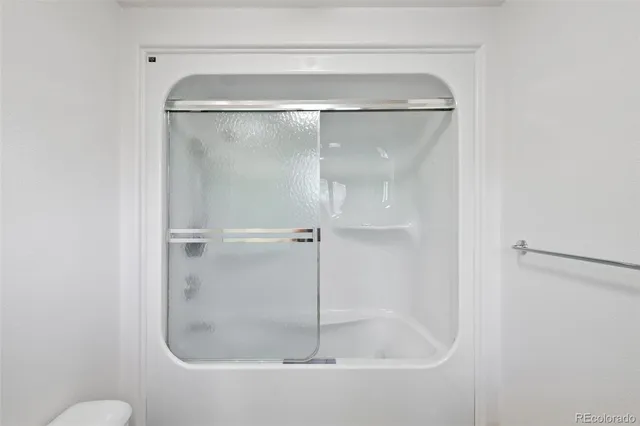 a bathroom with a glass shower door