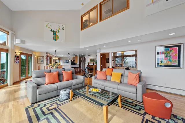 a living room with furniture and kitchen view