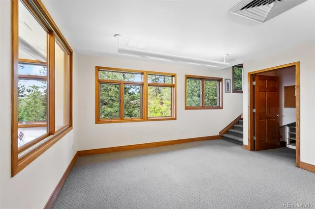 a view of empty room with a window and ceiling fan