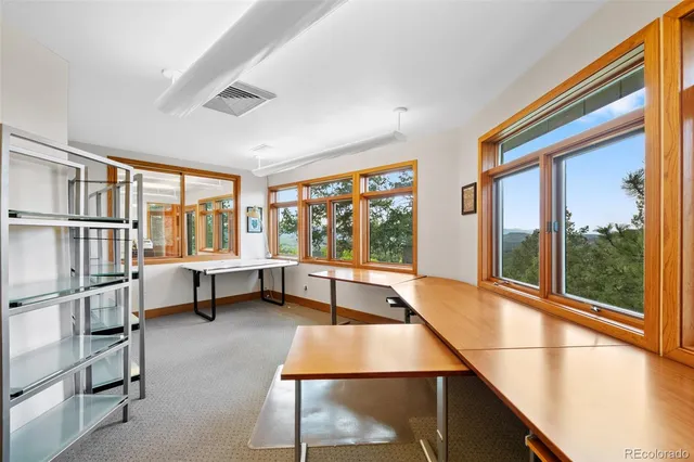 a room with pool table and a large window