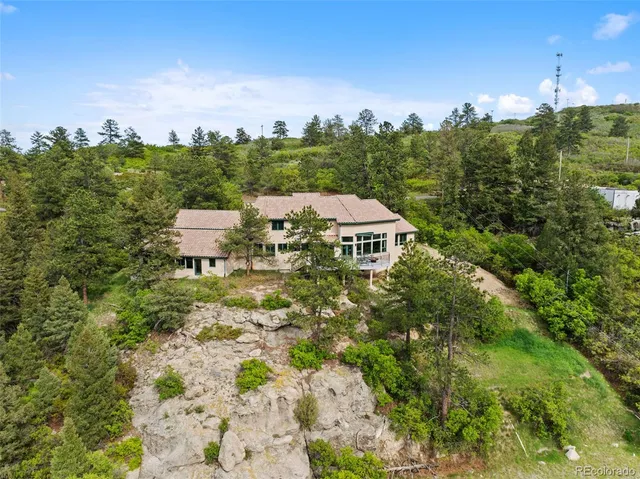 a view of a house with a yard and lake view