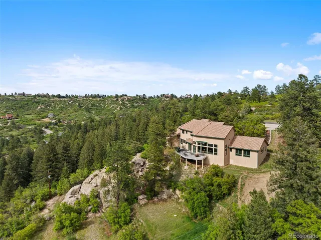 a view of a big yard with a mountain in the background